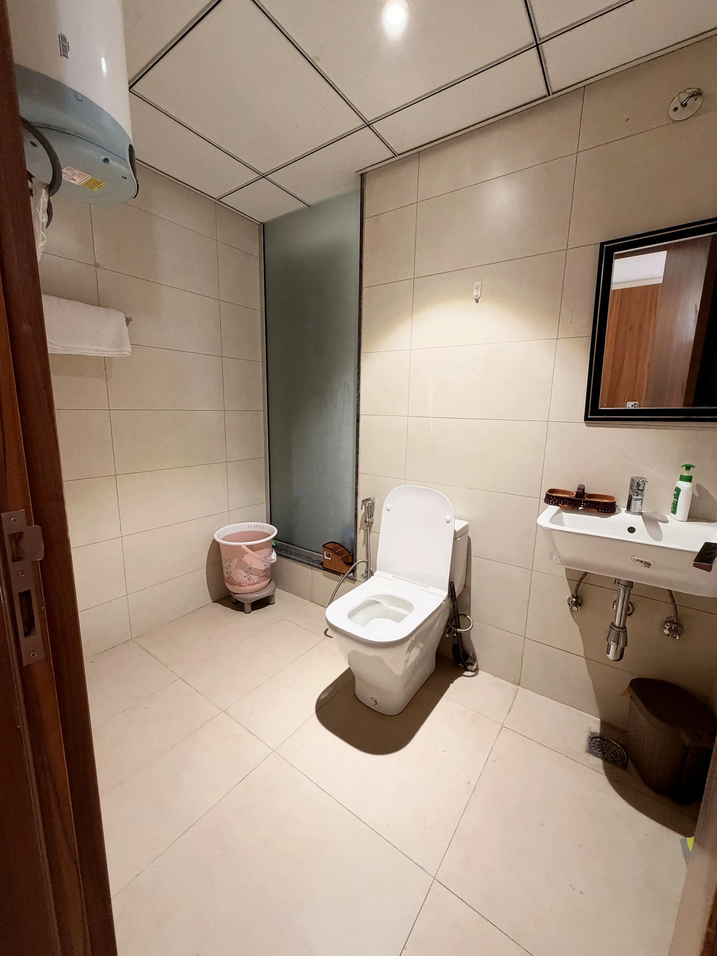 Bathroom two with a frosted-glass shower partition, WC and basin