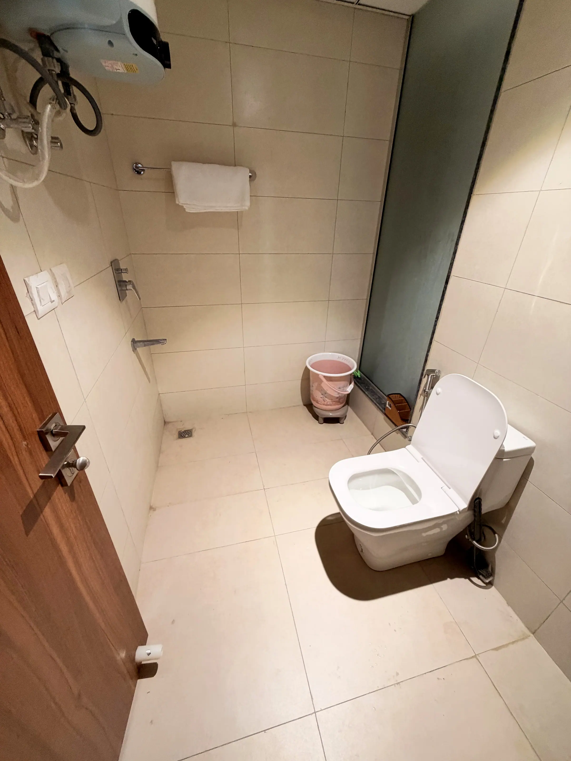 Shower area with geyser and towel rail in bathroom two