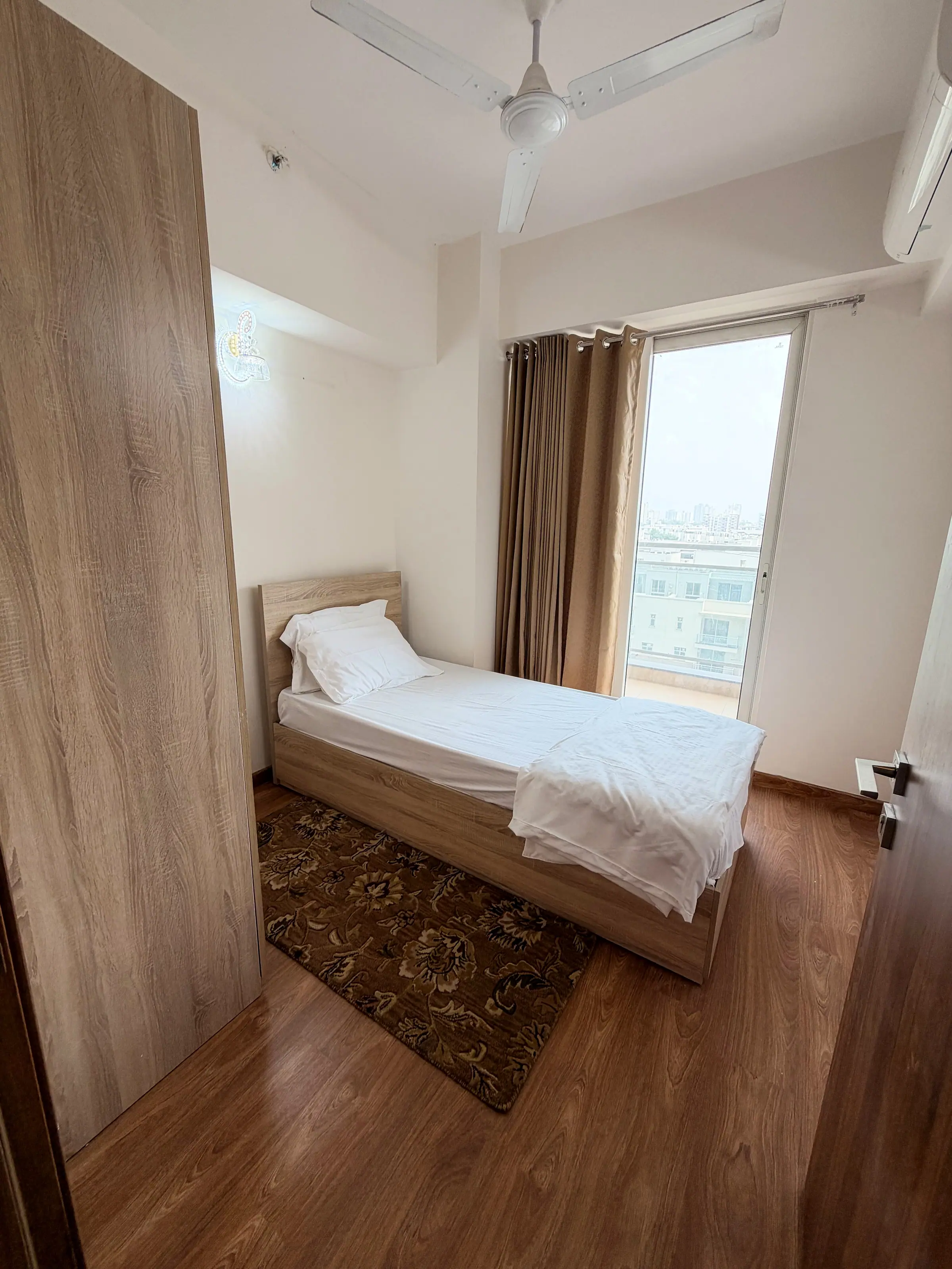 Bedroom two with a single bed by the window