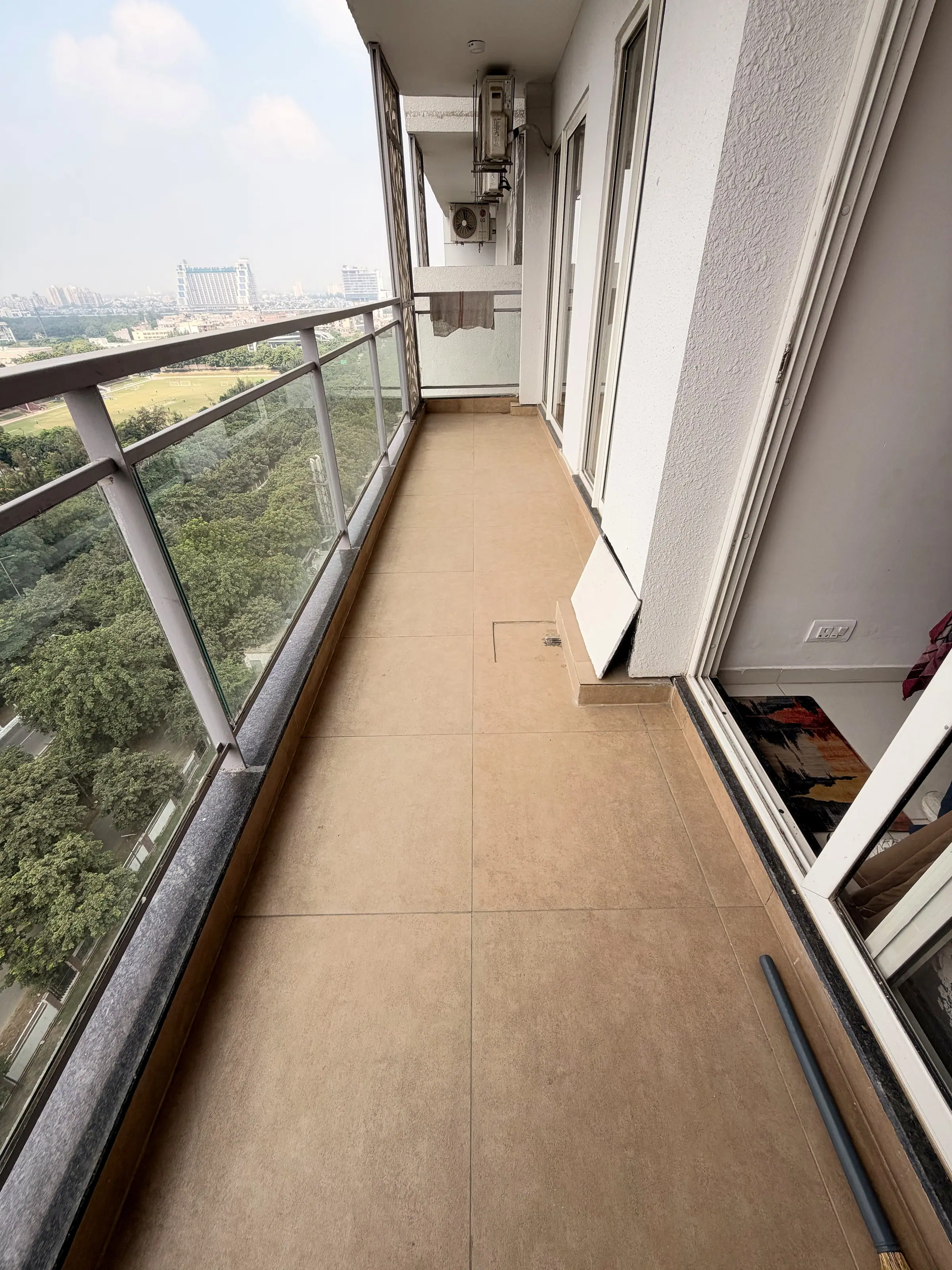 Balcony with a glass railing, high above the trees
