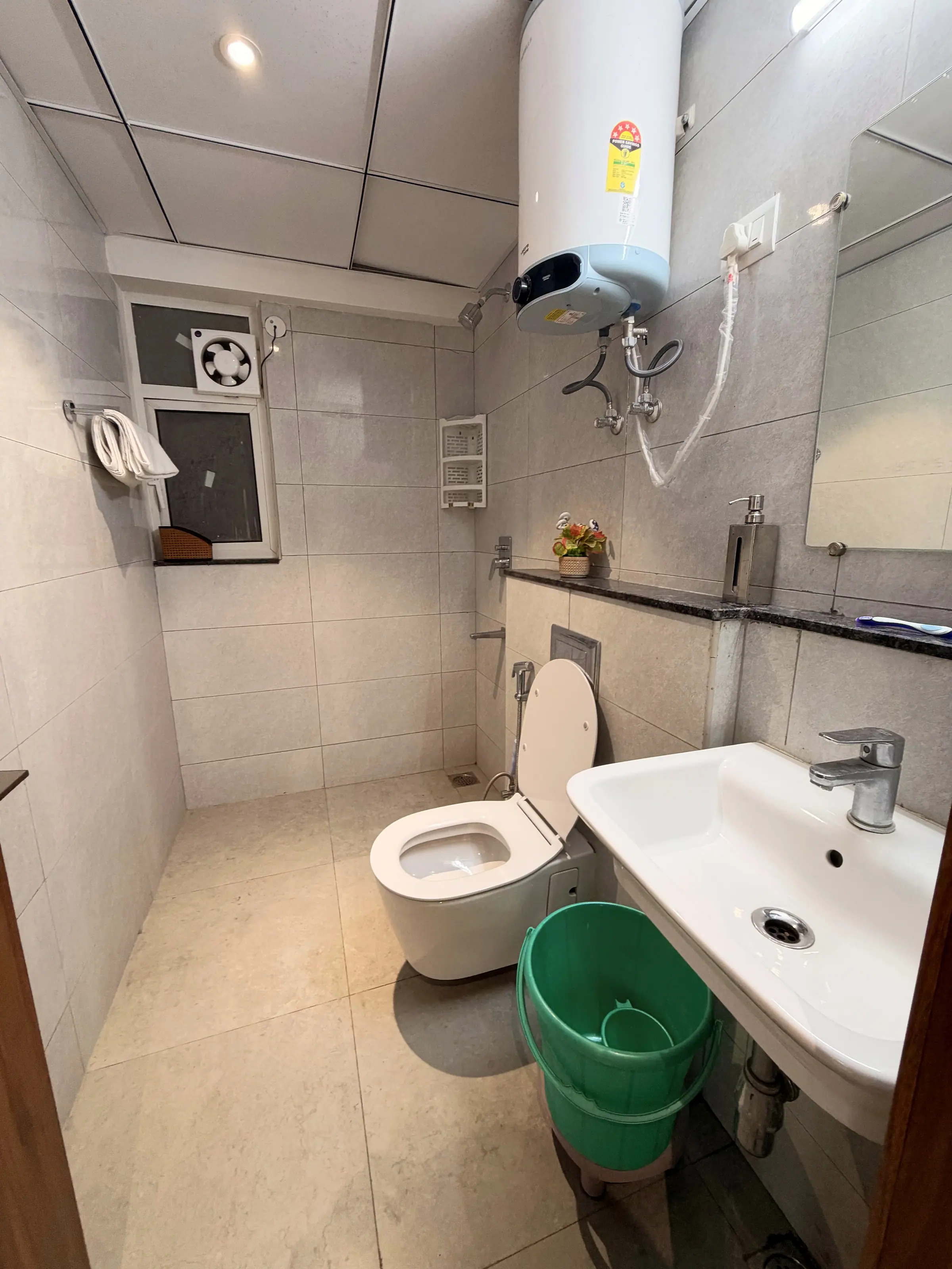 Geyser above the shower, WC and wall-hung basin