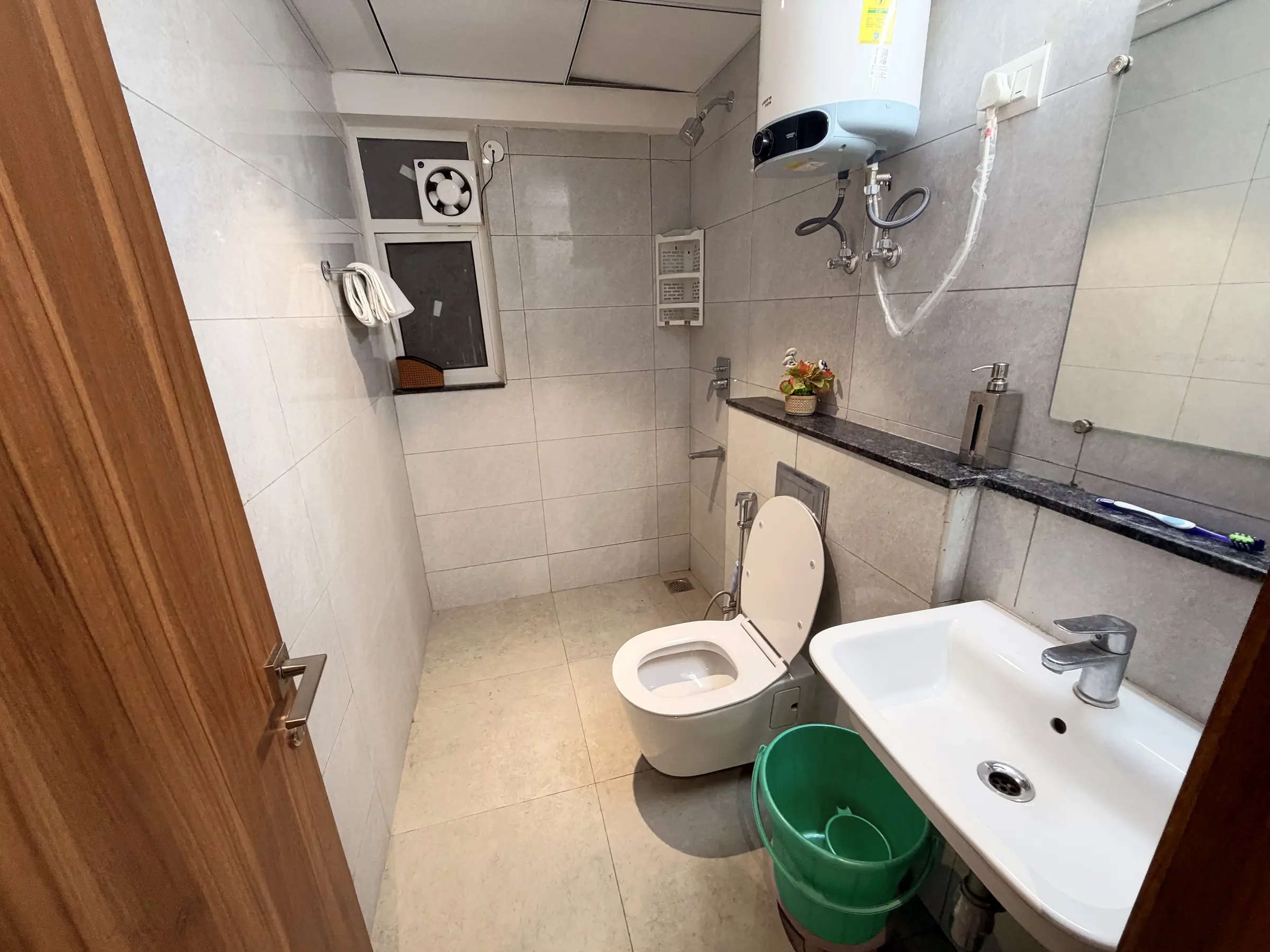 Second bathroom with geyser, basin, WC and a granite shelf